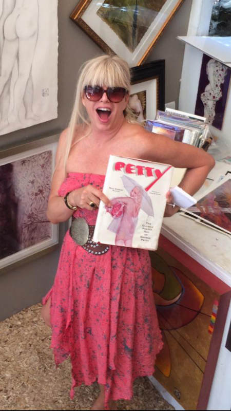 A portrait of Karen Petty holding a book